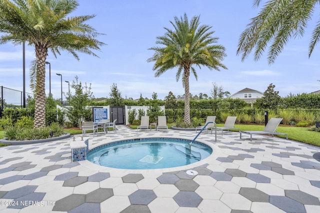 view of swimming pool featuring a community hot tub and a patio