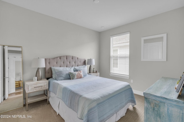 bedroom featuring light carpet