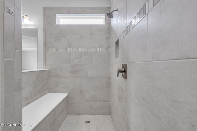 bathroom with tiled shower