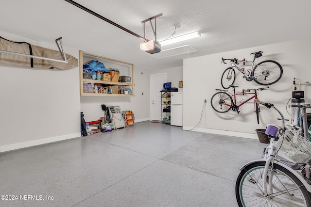 garage featuring a garage door opener and white fridge