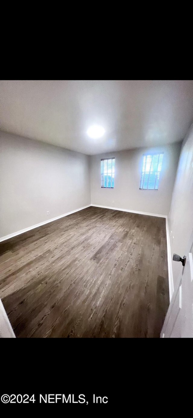 below grade area with baseboards and wood finished floors