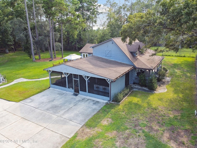 view of front facade with a front lawn and a carport