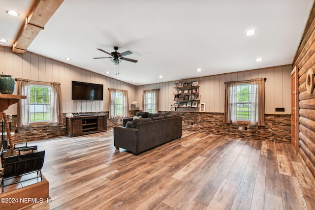 living room with hardwood / wood-style flooring, a wealth of natural light, and ceiling fan