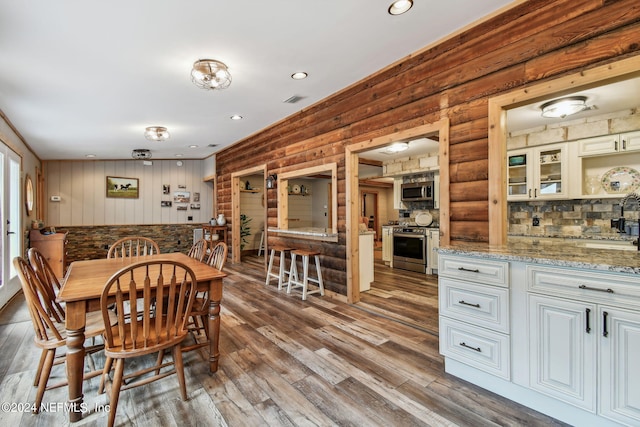 dining space with hardwood / wood-style floors