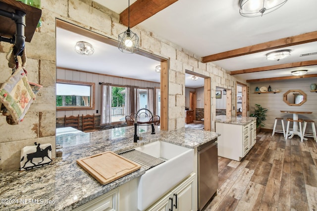 kitchen featuring sink, hanging light fixtures, beam ceiling, wood-type flooring, and light stone countertops