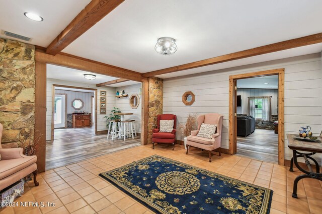 interior space featuring beamed ceiling and tile patterned flooring