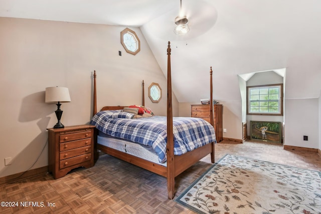 bedroom with dark parquet flooring and vaulted ceiling