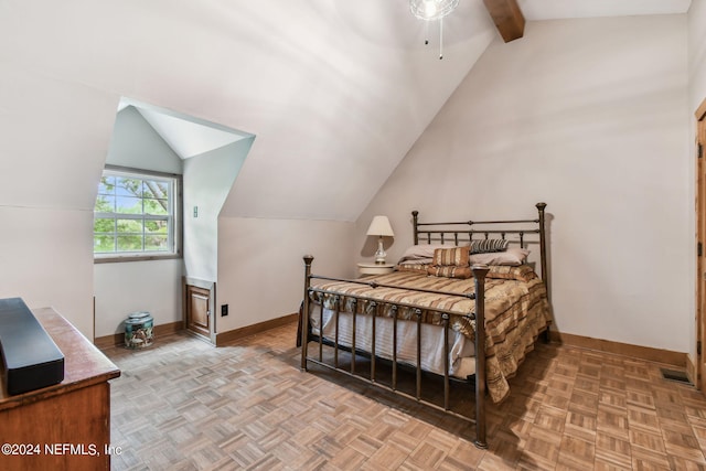 bedroom featuring light parquet floors and vaulted ceiling with beams