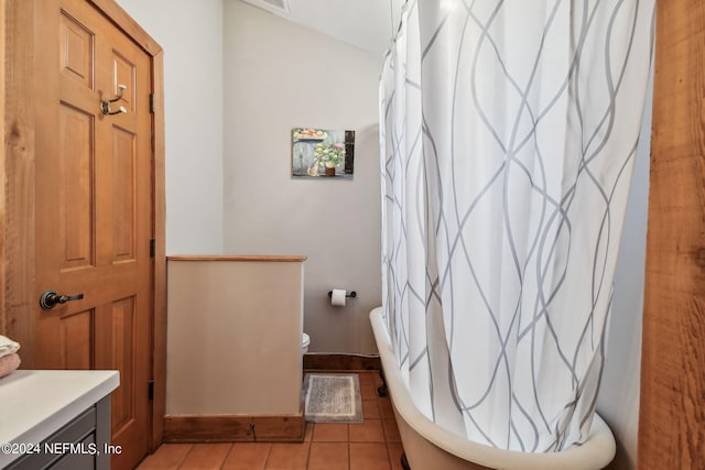 bathroom featuring vanity, a shower with curtain, tile patterned floors, and toilet