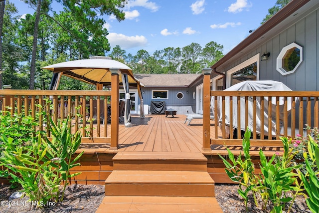 wooden terrace featuring a gazebo