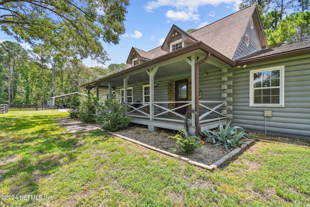 view of home's exterior featuring a lawn and covered porch