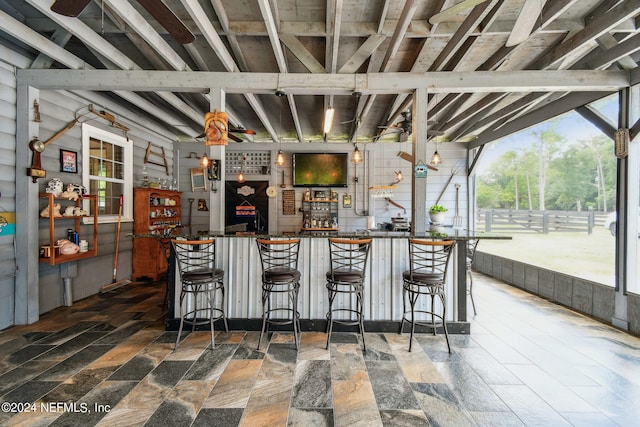 exterior space featuring a breakfast bar area and beamed ceiling