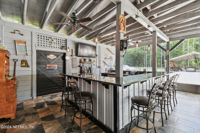 exterior space featuring wooden walls and ceiling fan