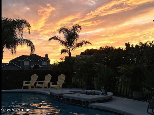 view of pool at dusk