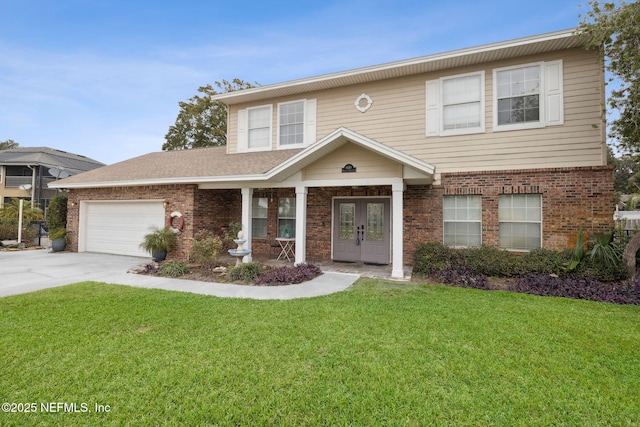 view of front facade with french doors, a front yard, and a garage