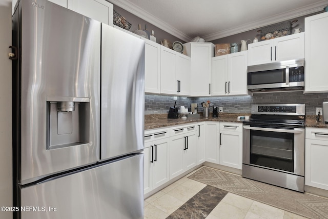 kitchen featuring white cabinets, dark stone countertops, and stainless steel appliances