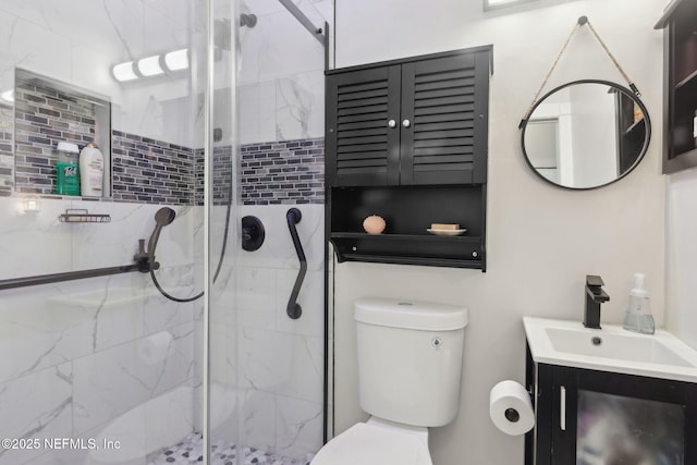 bathroom with vanity, toilet, and an enclosed shower