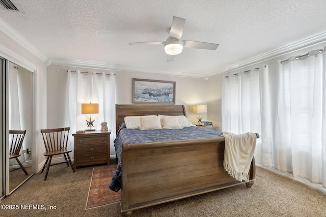 carpeted bedroom featuring ceiling fan, crown molding, and a textured ceiling