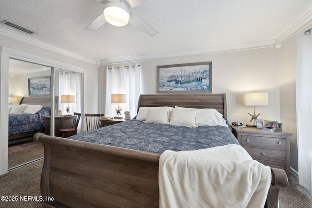 bedroom with dark carpet, a textured ceiling, ceiling fan, crown molding, and a closet