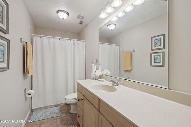 bathroom with vanity, a textured ceiling, and toilet