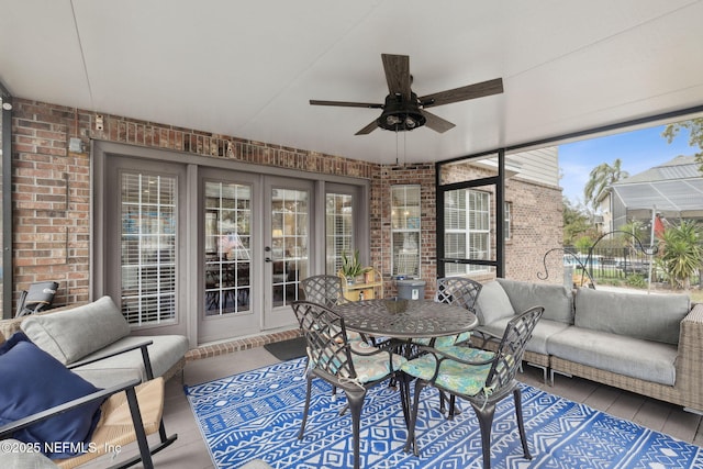 sunroom featuring ceiling fan and french doors