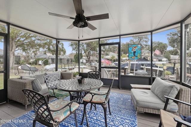 sunroom / solarium featuring ceiling fan and a healthy amount of sunlight