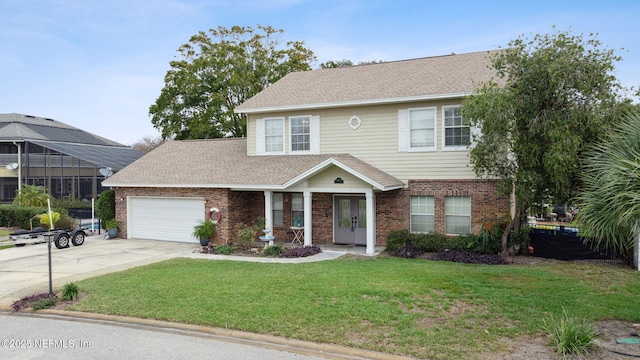 view of front of house with a garage and a front lawn