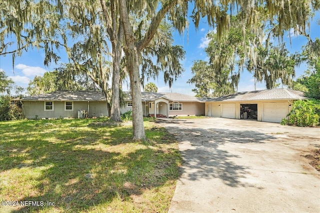 157 W Grandview Dr, East Palatka, FL 32131 - ranch-style house with concrete driveway, a front lawn, and a garage