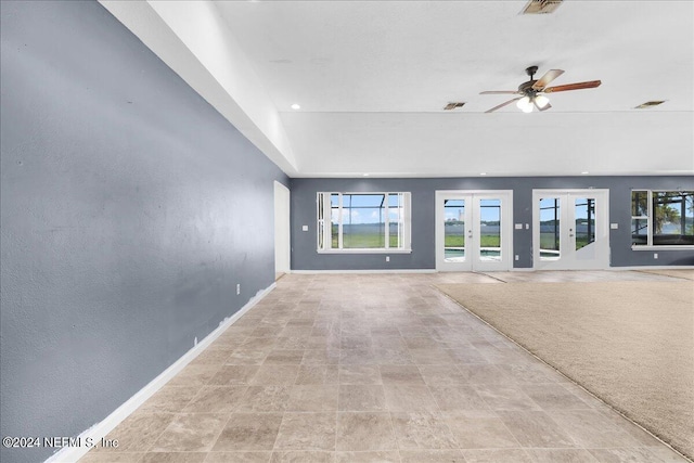 unfurnished living room with ceiling fan, light tile patterned floors, and french doors