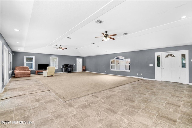 unfurnished living room with ceiling fan, light tile patterned floors, and lofted ceiling