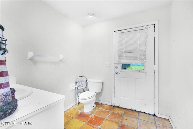 bathroom with tile patterned floors, vanity, and toilet