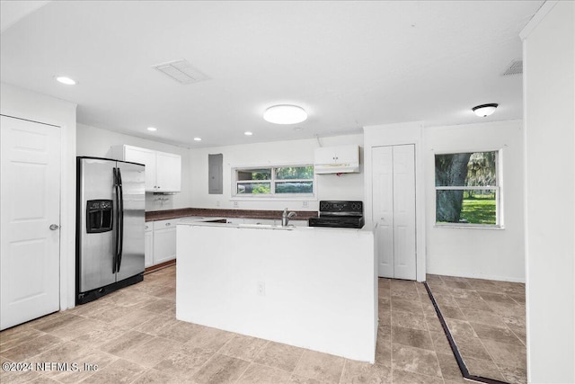 kitchen with stove, light tile patterned floors, stainless steel fridge with ice dispenser, a kitchen island, and white cabinetry