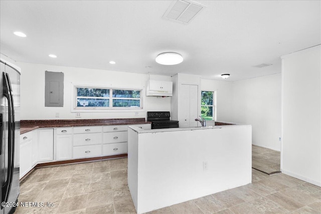 kitchen with range, light tile patterned flooring, white cabinetry, a center island, and electric panel