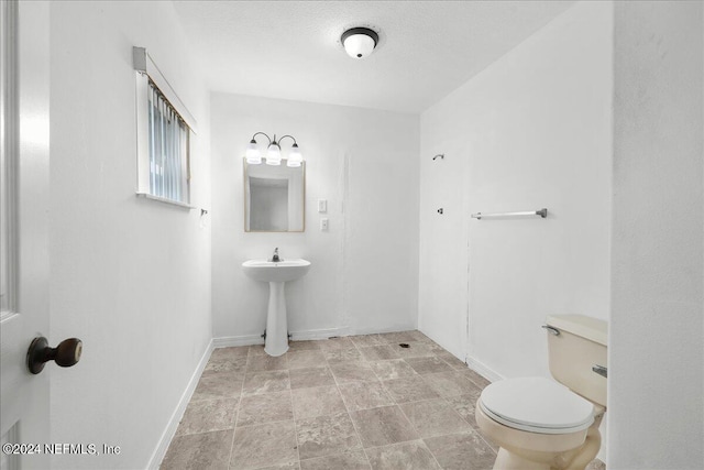 bathroom with sink, tile patterned flooring, and toilet