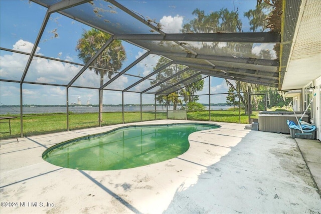 view of pool with a hot tub, a lanai, and a patio