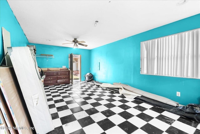 interior space with tile patterned flooring, ceiling fan, and a healthy amount of sunlight