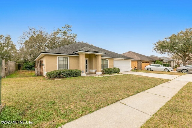 view of front of home with a garage, fence, driveway, stucco siding, and a front yard