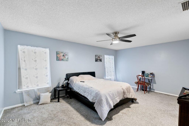 bedroom with a ceiling fan, carpet, visible vents, and baseboards