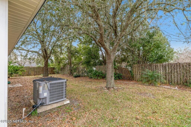 view of yard with a fenced backyard and central air condition unit