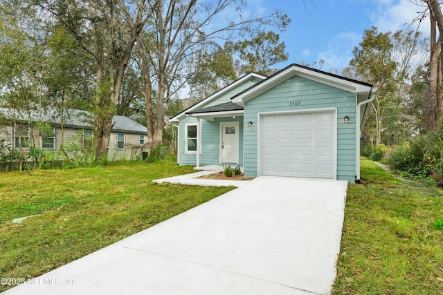 view of front of property featuring a garage and a front lawn