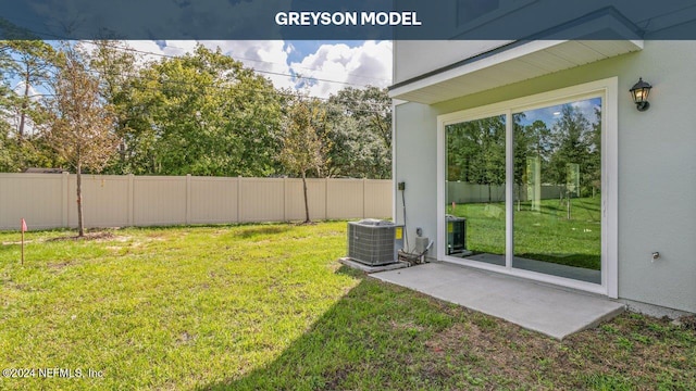 view of yard featuring cooling unit and a patio area