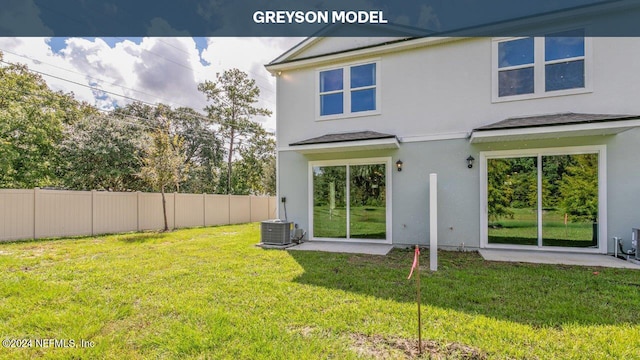 rear view of property featuring central AC unit, a patio, and a lawn