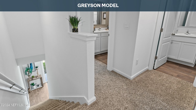 hallway with sink and hardwood / wood-style floors