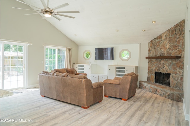 living room with ceiling fan, high vaulted ceiling, light wood-type flooring, and a fireplace