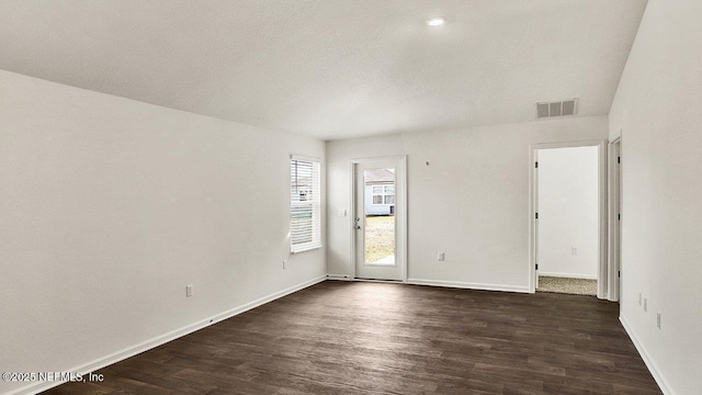 unfurnished room with dark hardwood / wood-style flooring