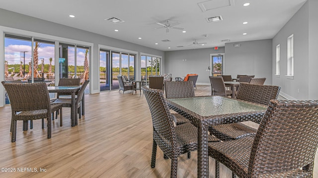 dining space with ceiling fan and light hardwood / wood-style floors