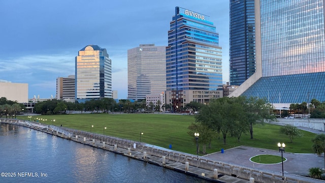 view of community with a lawn and a water view