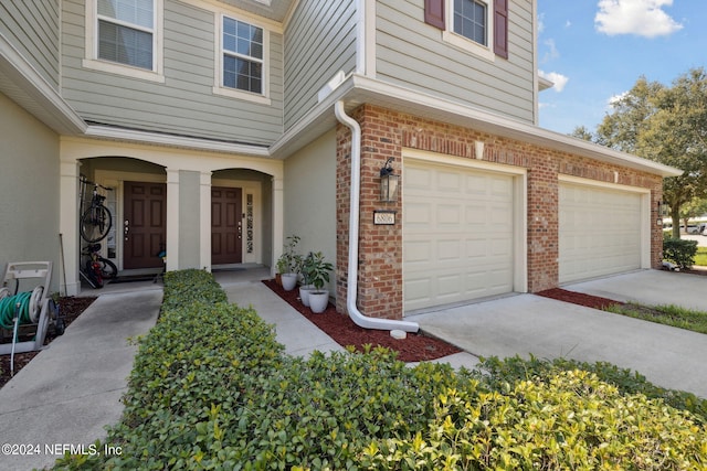 view of exterior entry featuring a garage