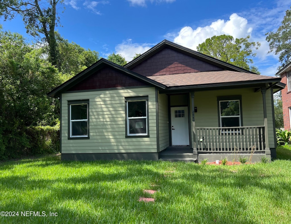 bungalow with a front lawn and a porch