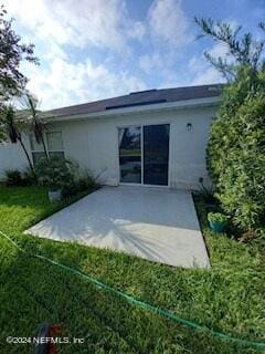 back of property featuring a patio area and stucco siding